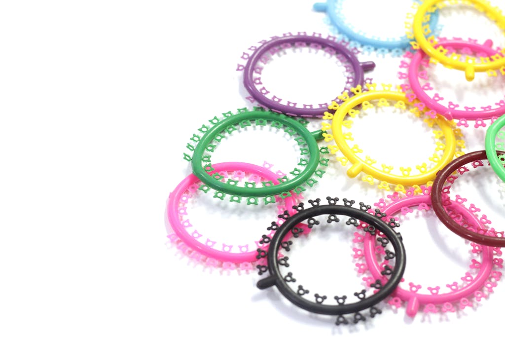 A vibrant mix of orthodontic braces bands in various colors on a white background.